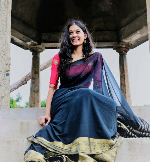 low-angle-view-cheerful-woman-wearing-sari-while-sitting-steps